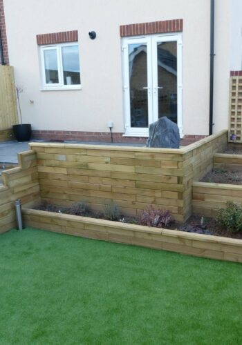 Multi-level new build garden design with steps and planters